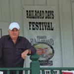 That is William Maurer standing in front of one of his caboose paintings.